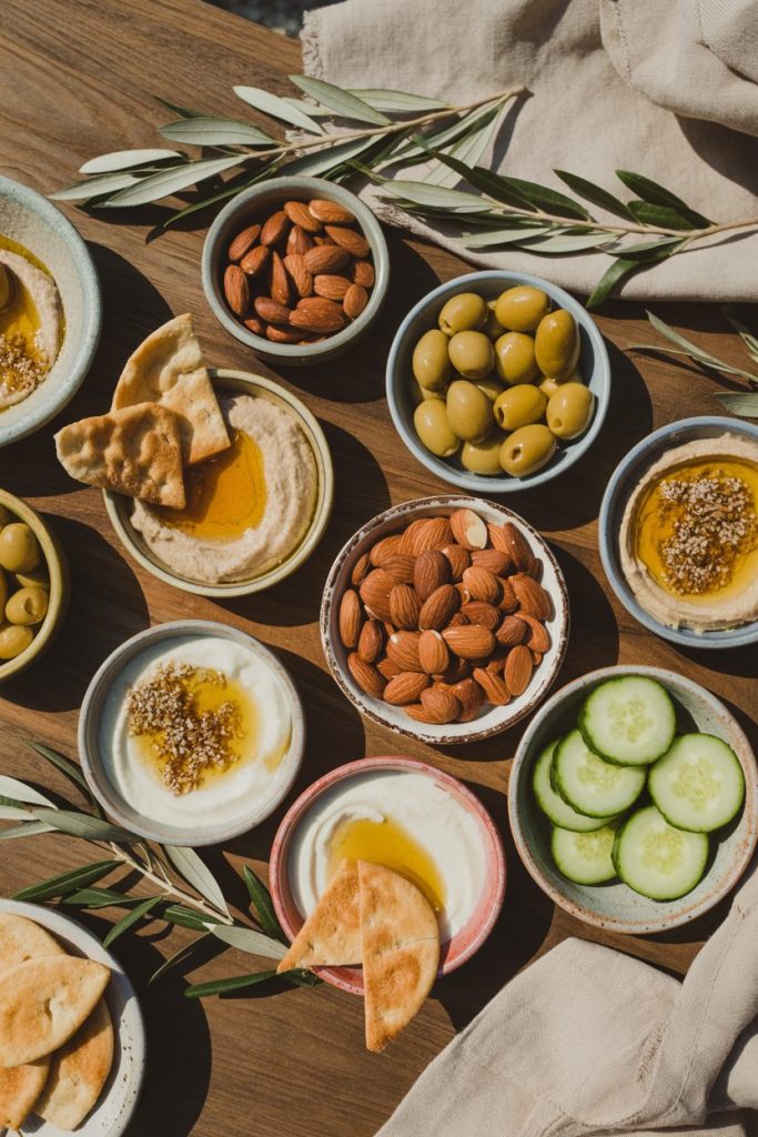 21 Mediterranean Snacks That Keep You Full 2 a photograph of a rustic wooden table ar Vu38MwqcQFmEnjvkb32NCA K3soYhUSHqTwoKwhA1fnw
